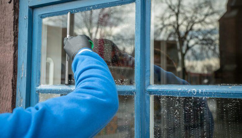 Person cleaning a window.