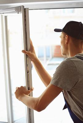 Worker performing a siding installation in Carrboro