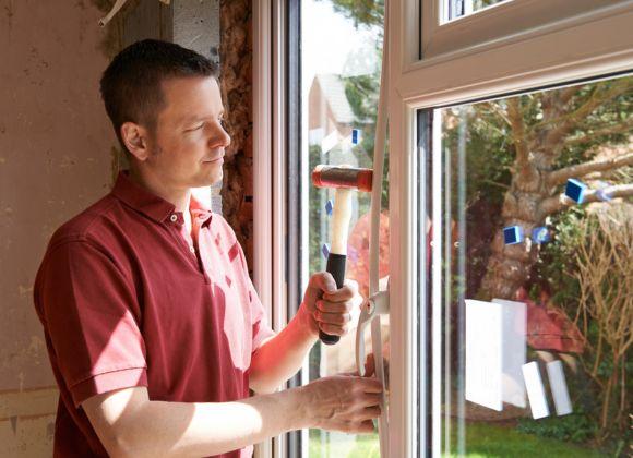 Contractor Finishing an Energy Efficient Window Installation in Oxford, NC